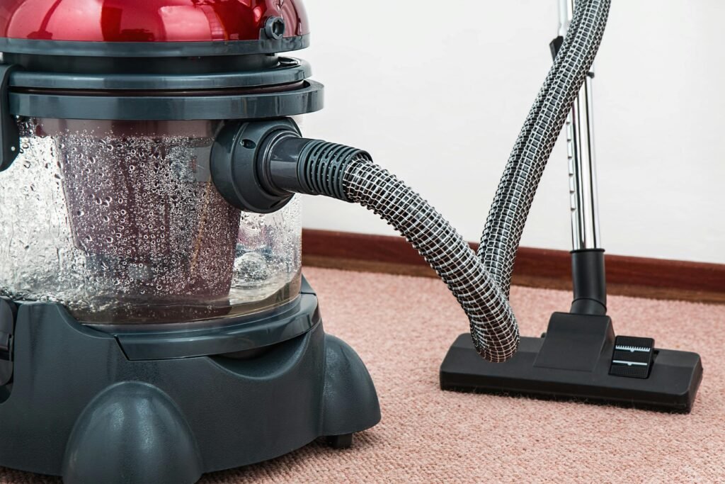 vacuum-cleaner-carpet-cleaner-housework-housekeeping-38325-38325 Close-up of a modern vacuum cleaner with water filtration on carpet floor indoors.